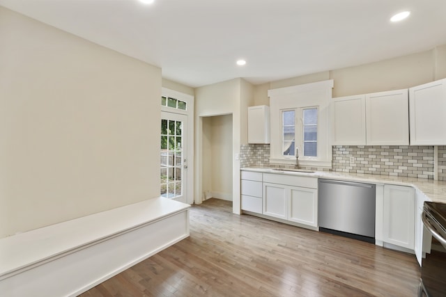 kitchen with dishwasher, white cabinets, light wood-type flooring, and sink