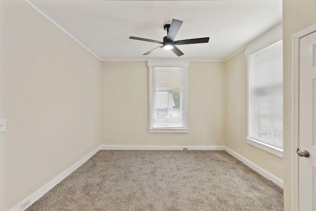 unfurnished room with crown molding, ceiling fan, a healthy amount of sunlight, and light carpet