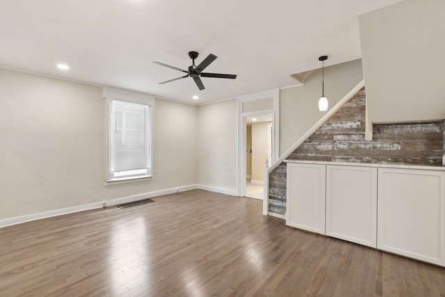 interior space featuring ceiling fan and wood-type flooring