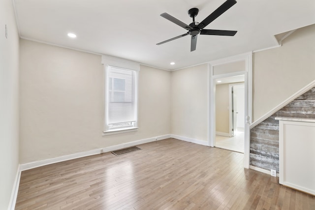 interior space with light hardwood / wood-style floors, ceiling fan, and ornamental molding