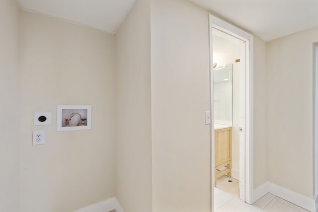 laundry area featuring hookup for an electric dryer, light tile patterned floors, and hookup for a washing machine