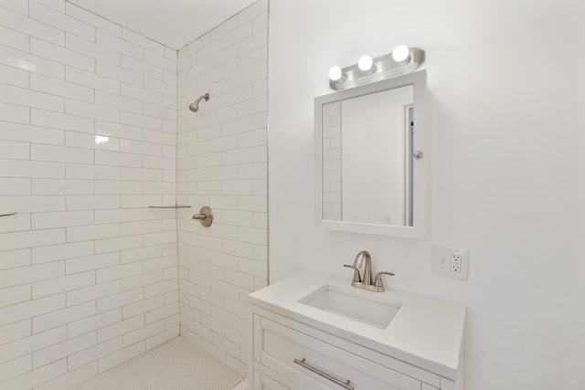 bathroom with vanity and tiled shower