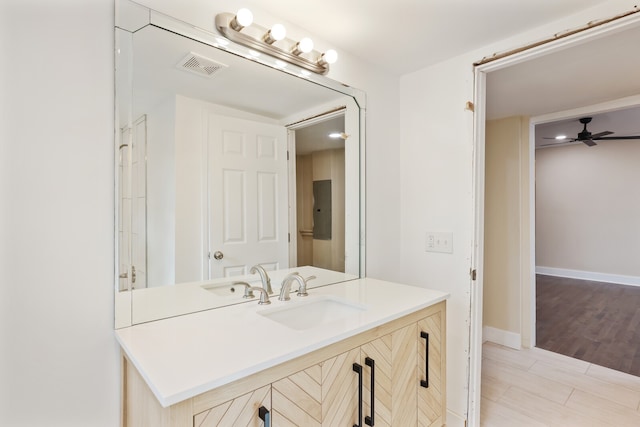 bathroom featuring hardwood / wood-style flooring, ceiling fan, and vanity