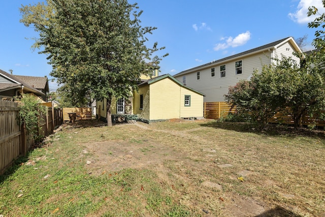 rear view of house featuring a lawn