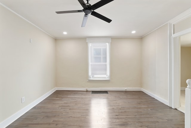 empty room featuring hardwood / wood-style flooring, ceiling fan, and crown molding