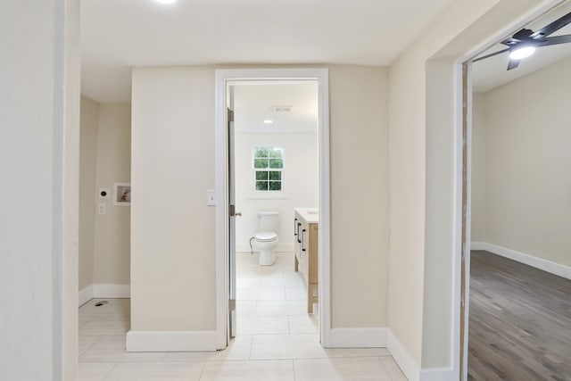 bathroom with hardwood / wood-style floors, vanity, toilet, and ceiling fan