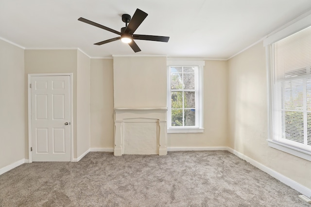 unfurnished living room with plenty of natural light, ceiling fan, light colored carpet, and ornamental molding