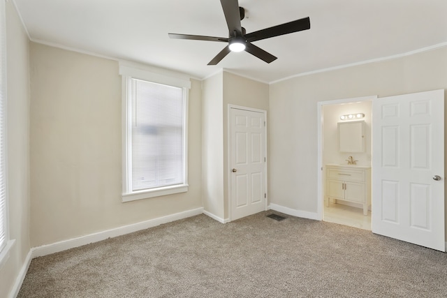 unfurnished bedroom with light carpet, ceiling fan, crown molding, sink, and connected bathroom