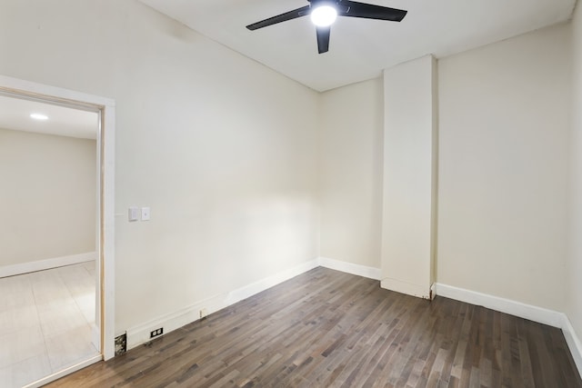 unfurnished room featuring ceiling fan and dark wood-type flooring