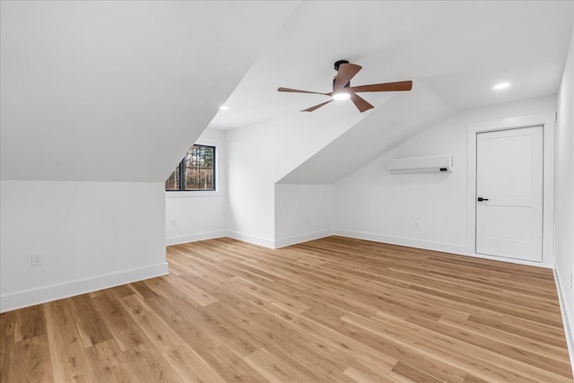 bonus room featuring a wall mounted AC, ceiling fan, lofted ceiling, and light wood-type flooring