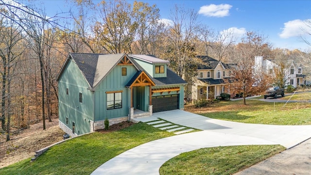 view of front facade featuring a garage, driveway, a front yard, and board and batten siding