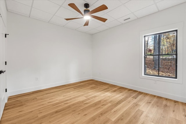 unfurnished room featuring a drop ceiling, ceiling fan, and light hardwood / wood-style flooring