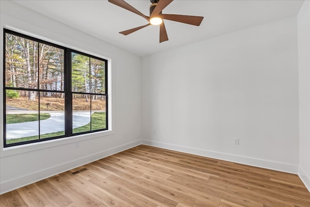 spare room with ceiling fan and light wood-type flooring