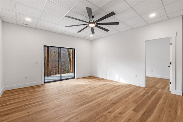 spare room featuring a paneled ceiling, light hardwood / wood-style floors, and ceiling fan