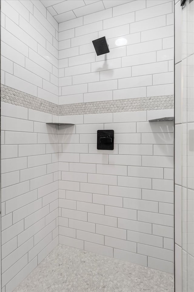 bathroom with a tile shower