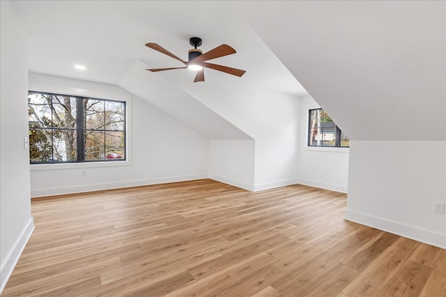 bonus room with vaulted ceiling, light hardwood / wood-style flooring, plenty of natural light, and ceiling fan