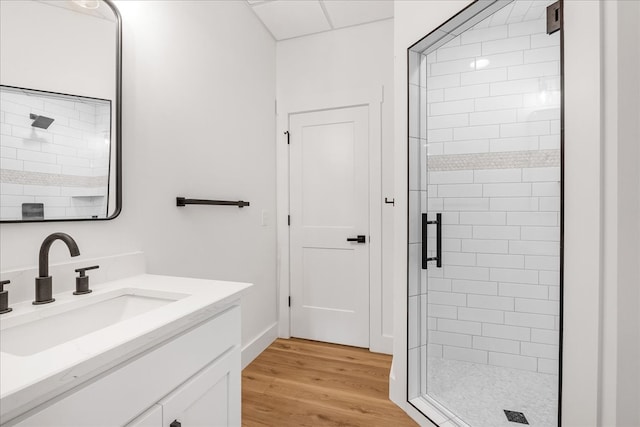 bathroom with vanity, wood-type flooring, and walk in shower