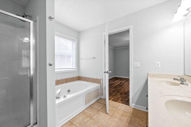 bathroom featuring tile patterned flooring, vanity, and shower with separate bathtub