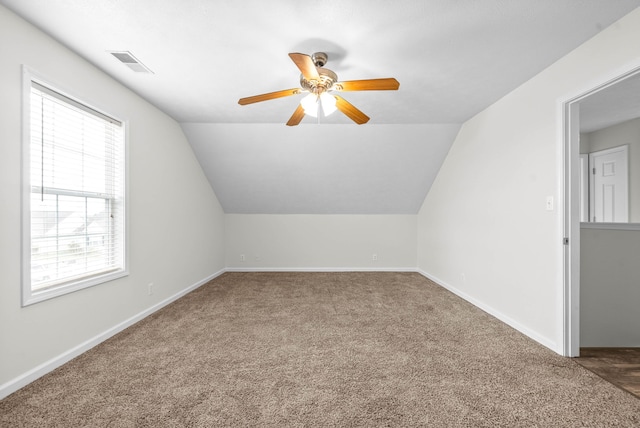 bonus room with lofted ceiling, ceiling fan, and carpet floors