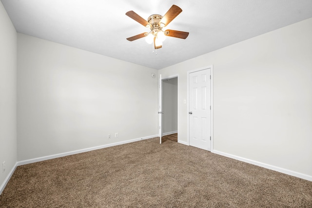 unfurnished room featuring ceiling fan and carpet