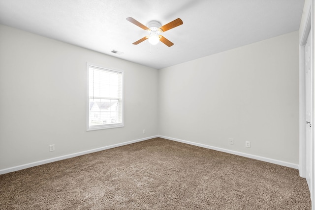 spare room with carpet floors and ceiling fan