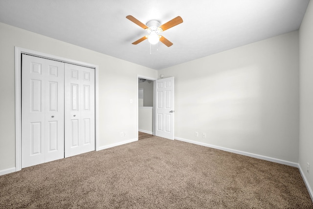 unfurnished bedroom with carpet, a closet, and ceiling fan