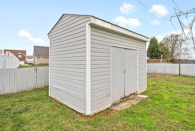 view of outbuilding featuring a lawn