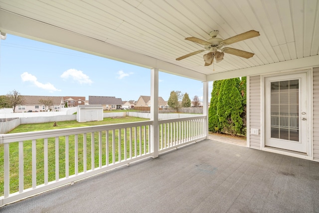 view of patio with ceiling fan and a storage shed