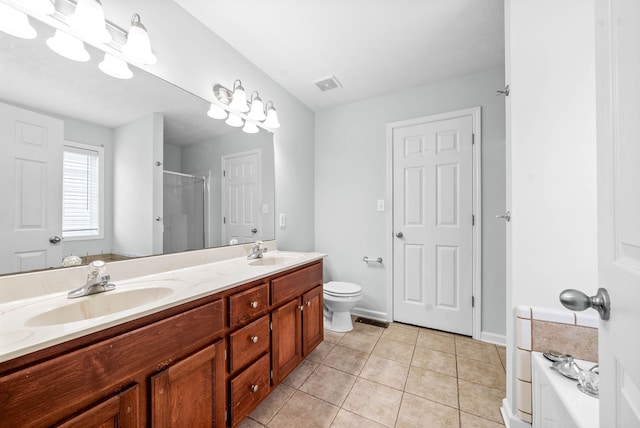 bathroom featuring tile patterned floors, vanity, toilet, and walk in shower