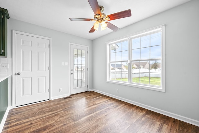 unfurnished room with ceiling fan and dark hardwood / wood-style floors