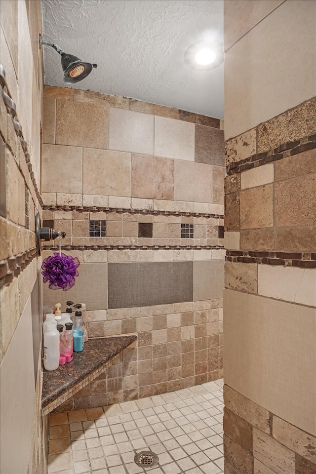 bathroom featuring a textured ceiling and walk in shower