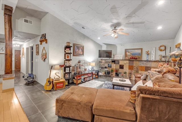 living room featuring hardwood / wood-style flooring, ceiling fan, and lofted ceiling