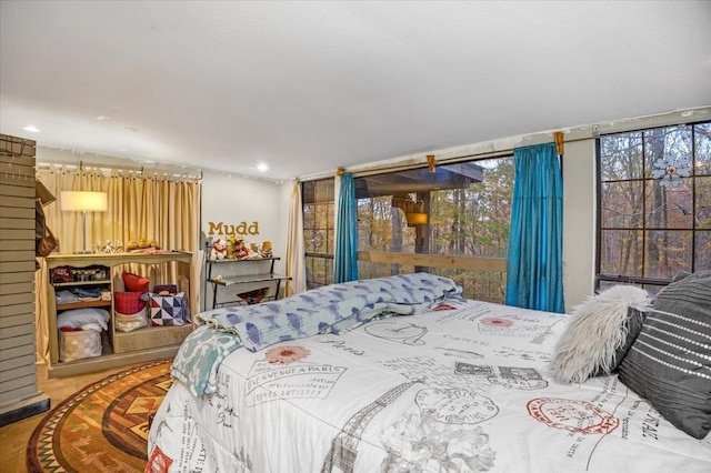 bedroom with hardwood / wood-style floors and multiple windows