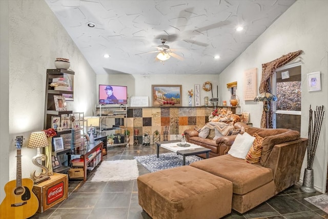 living room with dark tile patterned flooring and ceiling fan