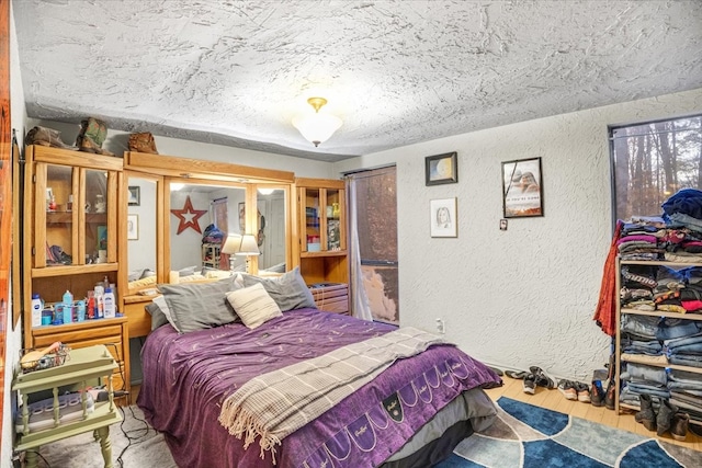 bedroom featuring hardwood / wood-style floors and a textured ceiling