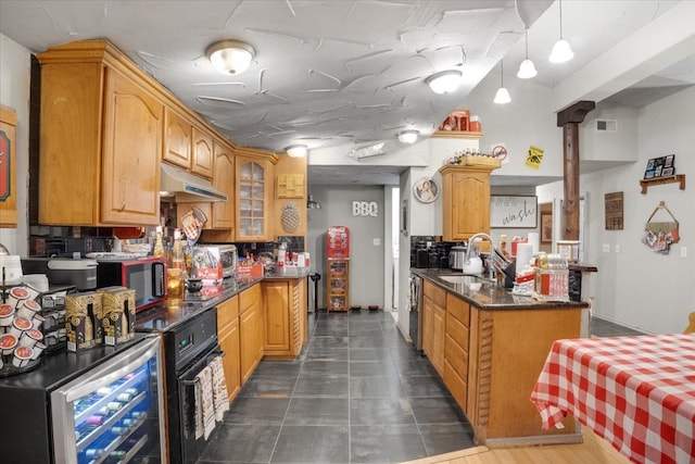 kitchen with decorative backsplash, decorative light fixtures, sink, and beverage cooler