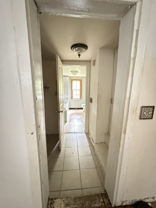 corridor featuring light tile patterned floors