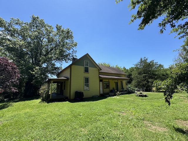 view of side of property with a yard