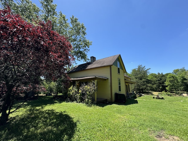 view of property exterior with a lawn