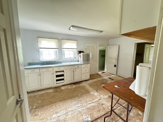 kitchen with white cabinetry and sink