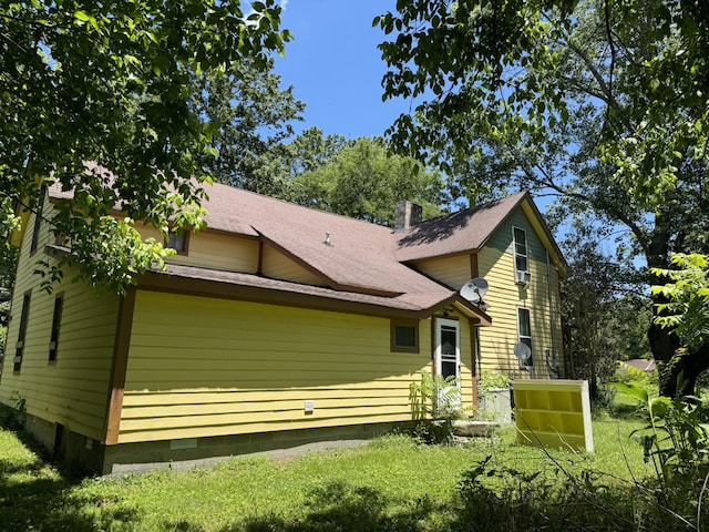 rear view of property with a yard