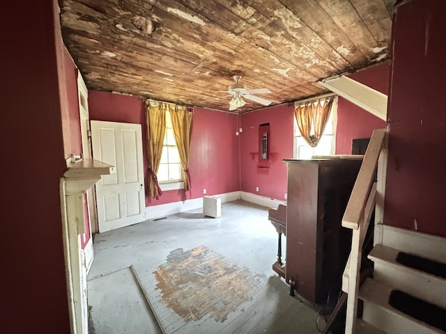 misc room with ceiling fan, electric panel, wood ceiling, and a wealth of natural light