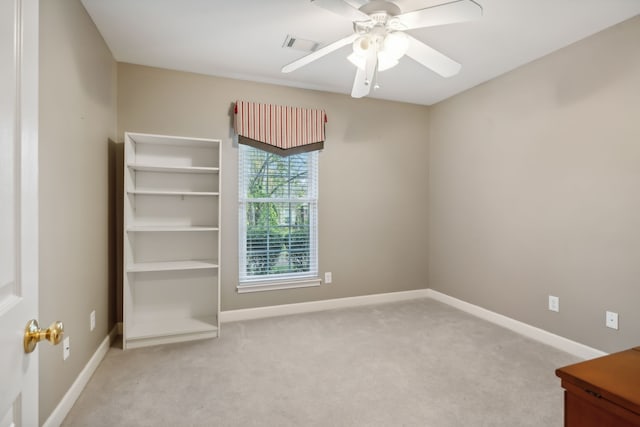 carpeted empty room featuring ceiling fan