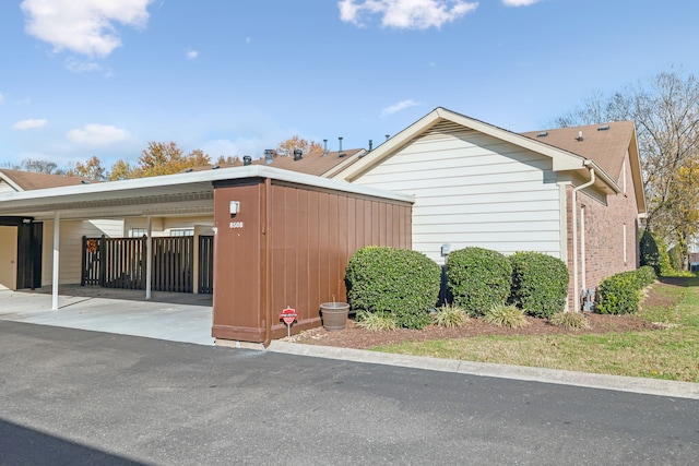 view of property exterior with a carport