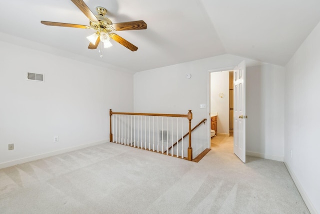 additional living space featuring ceiling fan, light colored carpet, and vaulted ceiling