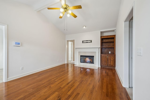 unfurnished living room with wood-type flooring, vaulted ceiling with beams, built in features, and ceiling fan