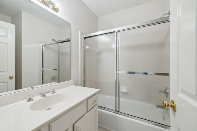 bathroom with vanity and enclosed tub / shower combo