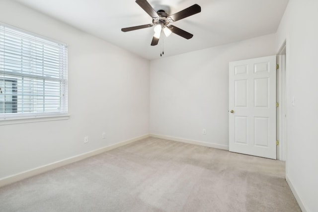 carpeted empty room with ceiling fan