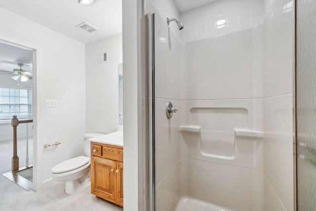 bathroom with ceiling fan, toilet, vanity, and walk in shower