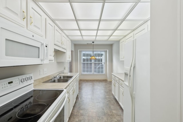 kitchen featuring white cabinetry, decorative light fixtures, and white appliances